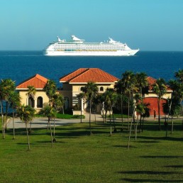 Casa Orange coastal home exterior with palm trees and tiled roofs