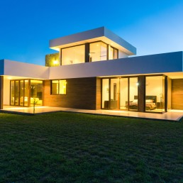 Ocean Hills Roatán – daytime front elevation of modern residence with porch by Hugo Coello Architects