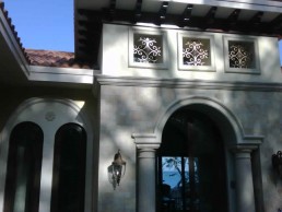 Arched entry facade with lantern lighting — Hugo Coello Architects