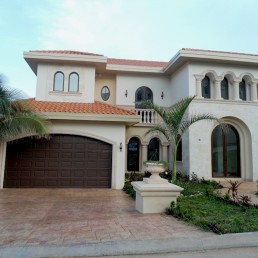 Casa Witty exterior—two-story white residence with shutters and balcony