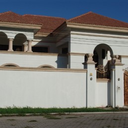 Casa Benitez exterior—two-story home with balcony and tiled roof