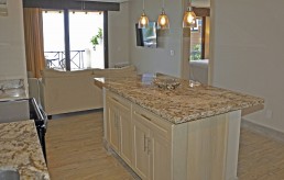 Guest room interior with queen bed, nightstands, and wall art