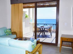 Hotel 9 – modern hotel corridor with ocean view through glass doors